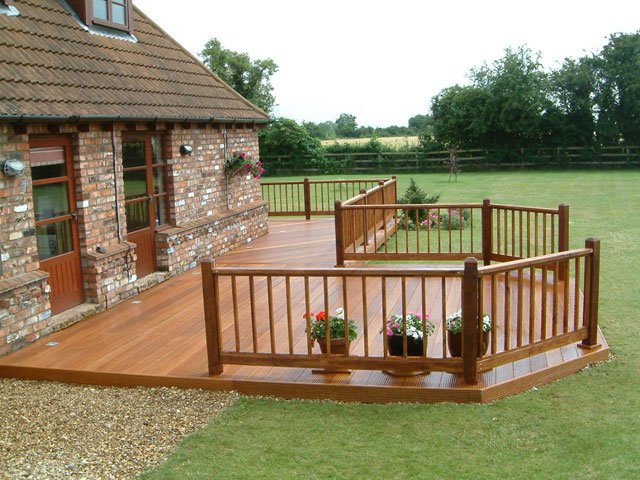 Timber decking and rail in front of house.